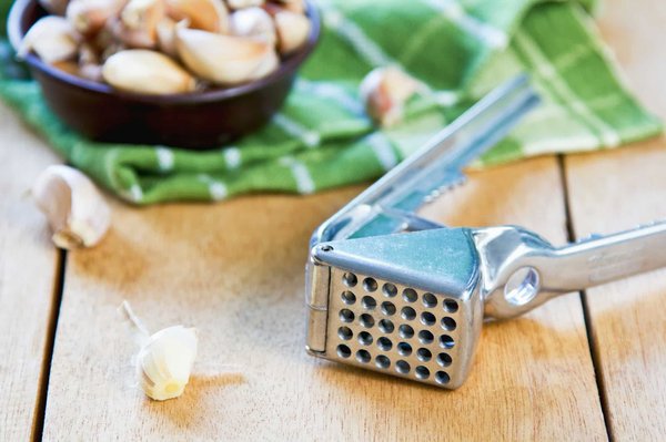 Which type of garlic press is easiest to clean and most durable?